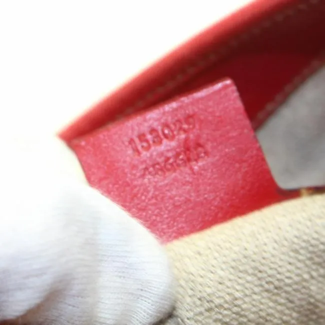 Vintage, Gucci, new Jackie style, red leather with a red, white, & blue center Sherry stripe, triangular shape, & gold hook closure